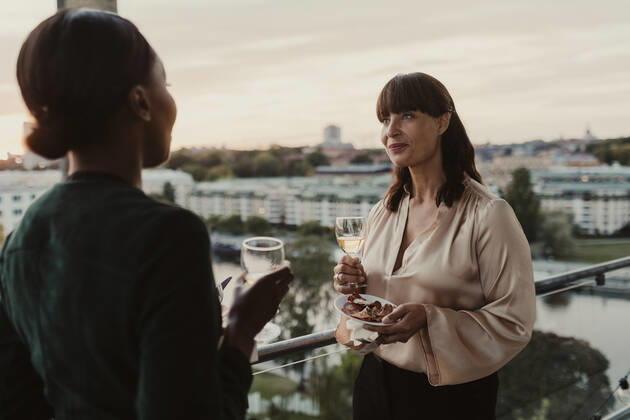 Smiling female colleagues with champagne in office during party Sweden, Stockholm, model released, property released Copyright: xMaskotx , MA84635