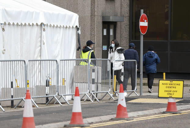 (210305) -- LONDON, March 5, 2021 -- People talk outside an NHS COVID-19 vaccination center in London, Britain, on March 4, 2021. Future vaccines that have been tweaked to deal with new coronavirus variants will be fast-tracked for authorization, Britain s medicines and health care regulator announced Thursday. ) BRITAIN-LONDON-COVID-19-VACCINE HanxYan 