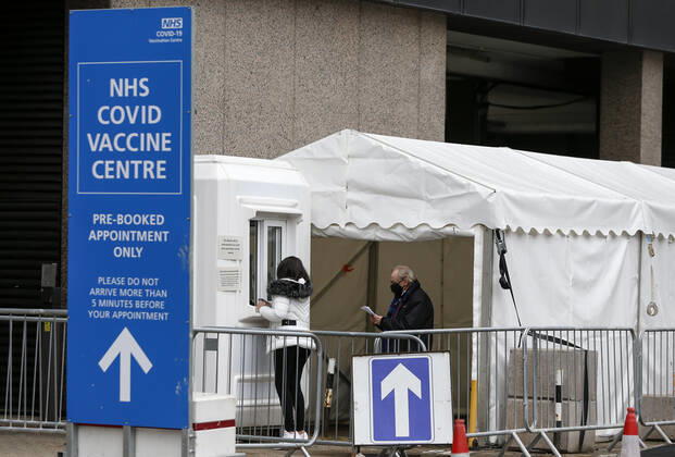 (210305) -- LONDON, March 5, 2021 -- People are seen at an NHS COVID-19 vaccination center in London, Britain, on March 4, 2021. Future vaccines that have been tweaked to deal with new coronavirus variants will be fast-tracked for authorization, Britain s medicines and health care regulator announced Thursday. ) BRITAIN-LONDON-COVID-19-VACCINE HanxYan 