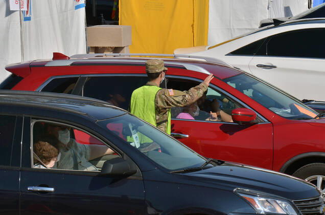 Military personnel administer COVID-19 shots to local residents at a drive-through vaccination site on the Cal State LA campus in Los Angeles on Thursday, March 4, 2021. California will begin sending 40% of all vaccine doses to the most vulnerable neighborhoods in the state to try to inoculate people most at risk from the coronavirus and get the state s economy open more quickly, Gov. Gavin Newsom said Thursday in the latest shake-up to the state s rules.  LAP2021030416 JIMxRUYMEN
