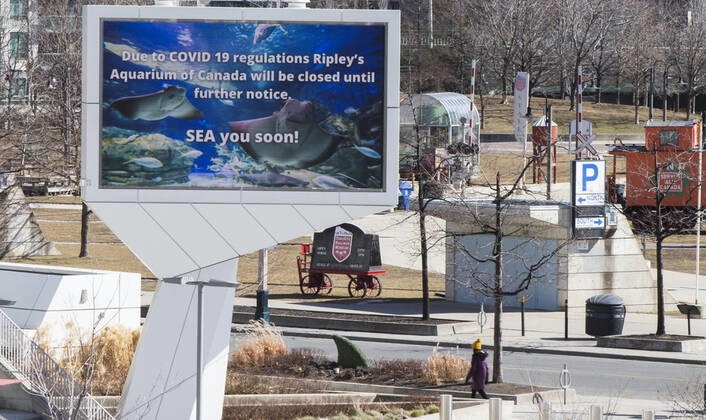 (210305) -- TORONTO, March 5, 2021 -- A woman walks past the closed Ripley s Aquarium of Canada in Toronto, Canada, on March 5, 2021. The global COVID-19 pandemic, including the associated restrictions and lockdowns over the past 12 months, have resulted in 8.35 billion Canadian dollars (about 6.6 billion U.S. dollars) in lost economic activity from visitor spending in Toronto, according to a press release by Destination Toronto on Thursday. (Photo by Xinhua) CANADA-TORONTO-COVID-19-TOURISM ZouxZheng 