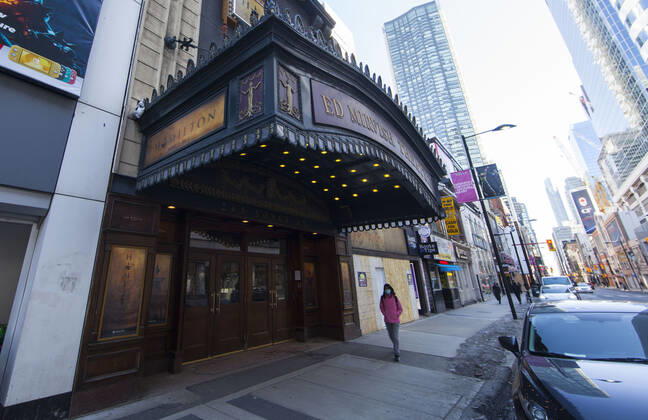 (210305) -- TORONTO, March 5, 2021 -- A woman wearing a face mask walks past a closed theater in Toronto, Canada, on March 5, 2021. The global COVID-19 pandemic, including the associated restrictions and lockdowns over the past 12 months, have resulted in 8.35 billion Canadian dollars (about 6.6 billion U.S. dollars) in lost economic activity from visitor spending in Toronto, according to a press release by Destination Toronto on Thursday. (Photo by Xinhua) CANADA-TORONTO-COVID-19-TOURISM ZouxZheng 