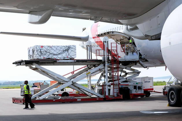 (210306) -- ENTEBBE, March 6, 2021 -- Photo taken on March 5, 2021 shows AstraZeneca-Oxford vaccines from COVAX vaccine sharing program being unloaded from a plane at Entebbe International Airport, Uganda. Uganda on Friday received the first batch of COVID-19 vaccines from COVAX facility. (Photo by Xinhua) UGANDA-ENTEBBE-COVAX-COVID-19 VACCINES-ARRIVAL HajarahxNalwadda 
