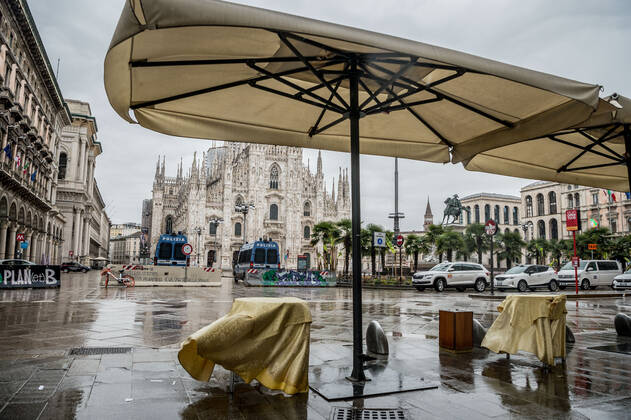 Milan. Dark Orange area few people in the street through the streets of the center In the photo closed bars in Piazza Duomo Editorial Usage Only  Copyright: xCarloxCozzolix xIPAx