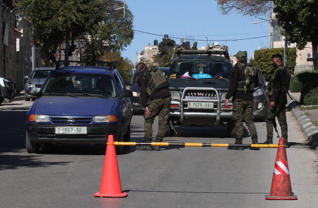 (210306) -- NABLUS, March 6, 2021 -- Palestinian police officers work at a checkpoint in the West Bank city of Nablus, March 6, 2021. Nablus Governor Ibrahim Ramadan announced on Thursday a total lockdown in his governorate for one week, starting Saturday, which includes a ban on movement of vehicles and closure of all shops and industries. Also on Thursday, Palestine extended its coronavirus-related state of emergency by a month following an increase in confirmed COVID-19 cases. (Photo by Xinhua) MIDEAST-NABLUS-COVID-19-LOCKDOWN NidalxEshtayeh 