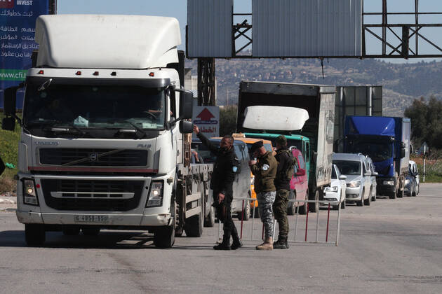 (210306) -- NABLUS, March 6, 2021 -- Palestinian police officers work at a checkpoint in the West Bank city of Nablus, March 6, 2021. Nablus Governor Ibrahim Ramadan announced on Thursday a total lockdown in his governorate for one week, starting Saturday, which includes a ban on movement of vehicles and closure of all shops and industries. Also on Thursday, Palestine extended its coronavirus-related state of emergency by a month following an increase in confirmed COVID-19 cases. (Photo by Xinhua) MIDEAST-NABLUS-COVID-19-LOCKDOWN NidalxEshtayeh 