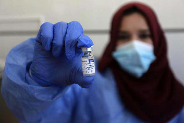 March 6, 2021, Bureij, Gaza Strip, Palestinian Territory: A Palestinian health worker prepares the vaccinate to a man, at a UN clinic in Al-Bureij camp in the central Gaza Strip, on March 6, 2021 Bureij Palestinian Territory - ZUMAap3_ 20210306_zaf_ap3_116 Copyright: xAshrafxAmrax