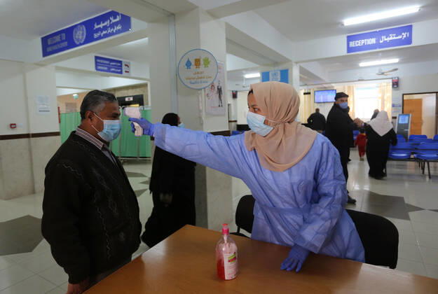 March 6, 2021, Bureij, Gaza Strip, Palestinian Territory: UNRWA employees wear face masks as the provide services in a UN clinic, in Al-Bureij camp in the central Gaza Strip, on March 6, 2021. UNRWA said that this year, the Agency will support approximately 1.25 million food-insecure Palestine refugees in the oPt through emergency food aid or cash assistance. Cash-for-work opportunities will help mitigate substantial loss of livelihoods, specifically in Gaza, and emergency education support will benefit more than 330,000 UNRWA students across the oPt Bureij Palestinian Territory - ZUMAap3_ 20210306_zaf_ap3_128 Copyright: xAshrafxAmrax