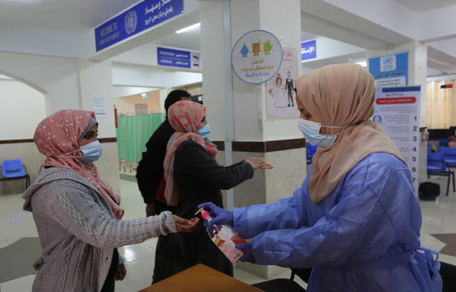 March 6, 2021, Bureij, Gaza Strip, Palestinian Territory: UNRWA employees wear face masks as the provide services in a UN clinic, in Al-Bureij camp in the central Gaza Strip, on March 6, 2021. UNRWA said that this year, the Agency will support approximately 1.25 million food-insecure Palestine refugees in the oPt through emergency food aid or cash assistance. Cash-for-work opportunities will help mitigate substantial loss of livelihoods, specifically in Gaza, and emergency education support will benefit more than 330,000 UNRWA students across the oPt Bureij Palestinian Territory - ZUMAap3_ 20210306_zaf_ap3_140 Copyright: xAshrafxAmrax