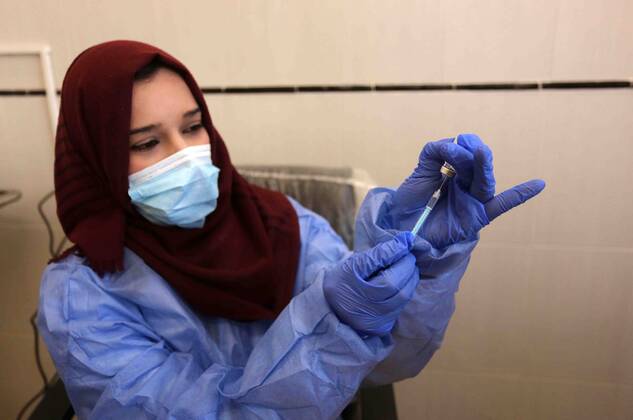 March 6, 2021, Bureij, Gaza Strip, Palestinian Territory: A Palestinian health worker prepares the vaccinate to a man, at a UN clinic in Al-Bureij camp in the central Gaza Strip, on March 6, 2021 Bureij Palestinian Territory - ZUMAap3_ 20210306_zaf_ap3_145 Copyright: xAshrafxAmrax