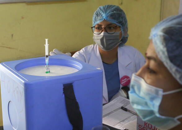 March 8, 2021, Kathmandu, Bagmati, Nepal: Female health workers prepare a dose of Covishield COVID-19 vaccine to be administered to an elderly person on International Women s Day at a hospital in Kathmandu,Nepal on March 8, 2021. Kathmandu Nepal - ZUMAs233 20210308_zap_s233_007 Copyright: xSunilxSharmax