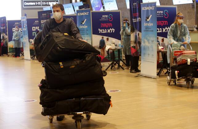 (210309) -- TEL AVIV, March 9, 2021 -- A traveler arrives at Ben Gurion International Airport near Tel Aviv, Israel, on March 8, 2021. Israel on Monday lifted the ban on entry of foreign nationals into the country, according to a statement issued by Israel s Population and Immigration Authority. (Photo by Xinhua) ISRAEL-AIRPORT-COVID-19-CONTROL MEASURES GilxCohenxMagen 