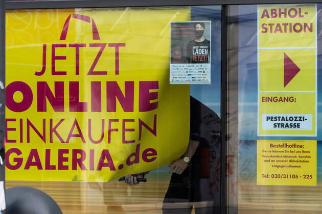(210309) -- BERLIN, March 9, 2021 -- A shop assistant puts up an advertisement of online shopping in Berlin, Germany, on March 9, 2021. Stores in Berlin were allowed to reopen with hygienic requirements and restrictions on Tuesday. (Photo by Xinhua) GERMANY-BERLIN-COVID-19-STORES-REOPENING StefanxZeitz 