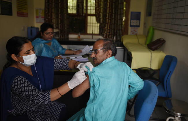 GURUGRAM, INDIA - MARCH 9: An elderly man gets vaccinated against Covid-19, at Urban Primary Health Centre, at Wazriabad, on March 9, 2021 in Gurugram, India. (Photo by Vipin Kumar Hindustan Times )