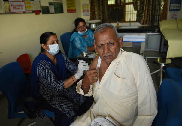 GURUGRAM, INDIA - MARCH 9: An elderly man gets vaccinated against Covid-19, at Urban Primary Health Centre, at Wazriabad, on March 9, 2021 in Gurugram, India. (Photo by Vipin Kumar Hindustan Times )