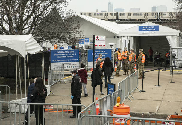 (210310) -- CHICAGO, March 10, 2021 -- People line up to enter a mass COVID-19 vaccination site at the United Center in Chicago, the United States, on March 10, 2021. The mass COVID-19 vaccination site started running at the arena on Tuesday. (Photo by Xinhua) U.S.-CHICAGO-MASS VACCINATION SITE-OPENING JoelxLerner 