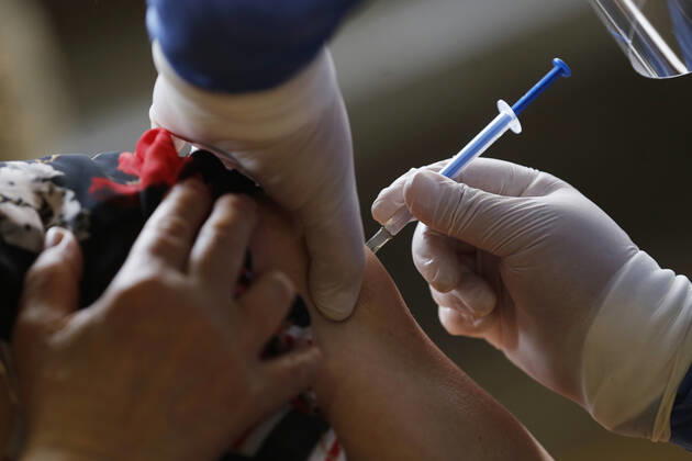 March 10, 2021, Uruapan, Michoacan, Mexico: A person receives a dose of Pfizer-BioNTech Covid-19 vaccine before inject to an elderly, during mass vaccine inside of Hermanos Lopez Rayon sports center, a designated priority vaccination center for elderly over 60 years in the Uruapan town. On March 10, 2021 in Michoacan, Mexico. Uruapan Mexico - ZUMAe321 20210310_zia_e321_004 Copyright: xCarlosxGuzmanx