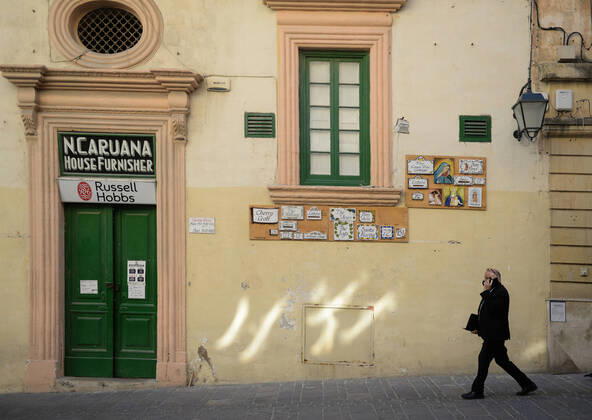 (210311) -- VALLETTA, March 11, 2021 -- A man wearing a face mask walks on an empty street in Valletta, Malta, March 11, 2021. The Maltese government on Wednesday announced the closure of schools and non-essential shops in response to a spike in new COVID-19 cases, almost two-thirds of which are attributable to the variant first reported in the UK. The new measures, which will be in force until April 11, include the closure of all non-essential shops and those providing non-essential services such as hairdressers and beauticians while the limitation of group gatherings in public down to a maximum of four people. (Photo by Xinhua) MALTA-VALLETTA-COVID-19-RESTRICTIONS JonathanxBorg 