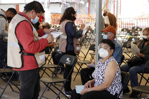 MEXICO CITY, MEXICO - MARCH 11: A worker fill a form of a elderly inside of the Autonomous Metropolitan University Azcapotzalco, previous that a health worker apply the Pfizer BioNTech Covid19 vaccine to adults over 60 years of age, in the Third Stage of Vaccination. On March 11, 2021 in in Mexico City, Mexico.. Credit: Luis Barron Eyepix Group The Photo Access Increased COVID Vaccination for Elderly in Mexico  Copyright: xLuisxBarronx