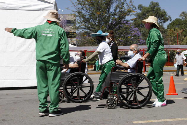 MEXICO CITY, MEXICO - MARCH 11: Staff of various social programmes, support to elderly over to move in wheelchairs to arrive at the facilities of the Autonomous Metropolitan University Azcapotzalco, where health workers apply the Pfizer BioNTech Covid19 vaccine to adults over 60 years of age, in the Third Stage of Vaccination. On March 11, 2021 in in Mexico City, Mexico.. Credit: Luis Barron Eyepix Group The Photo Access Increased COVID Vaccination for Elderly in Mexico  Copyright: xLuisxBarronx