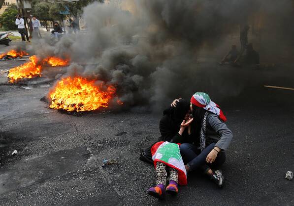 April 8, 2021, Beirut, Beirut, Lebanon: Lebanese protester kisses the head of an elderly female protester during a protest against the power cuts, the high cost of living, the low purchasing power of the Lebanese pound, Beirut, Lebanon, March 12, 2021. Protesters in all Lebanon burned tires and garbage where they blocked all main roads. State-provided electricity in Beirut has reached record-low levels that seem insurmountable for financial reasons Beirut Lebanon - ZUMAap3_ 20210408_zaf_ap3_001 Copyright: xMarwanxBouxHaidarx
