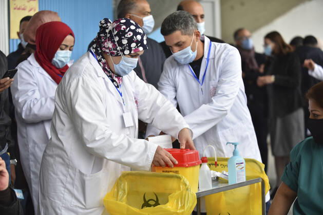 TUNIS, TUNISIA - MARCH 13: A healthcare personnel receives the first dose of the Sputnik V coronavirus (COVID-19) vaccine at a sahra hospital established in El Menzah Sports Palace as vaccination process begins in Tunis, Tunisia on March 13, 2021. NEWS : Debut du processus de vaccination a Tunis - 13 03 2021 WassimJdidi Panoramic 