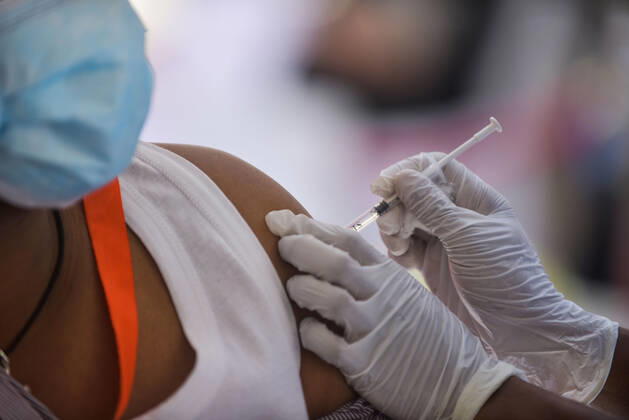 (210313) -- ADDIS ABABA, March 13, 2021 -- A medical worker administers the COVID-19 vaccine to a recipient in Addis Ababa, Ethiopia, on March 13, 2021. Ethiopian State Minister of Health Dereje Duguma disclosed on Saturday that the east African country plans to give COVID-19 vaccine jabs to 20 percent of its population by March 2022. Duguma disclosed the plan during a ceremony in Addis Ababa to officially start COVID-19 vaccine jabs in the country. ) ETHIOPIA-ADDIS ABABA-COVID-19 VACCINATION-START MichaelxTewelde 