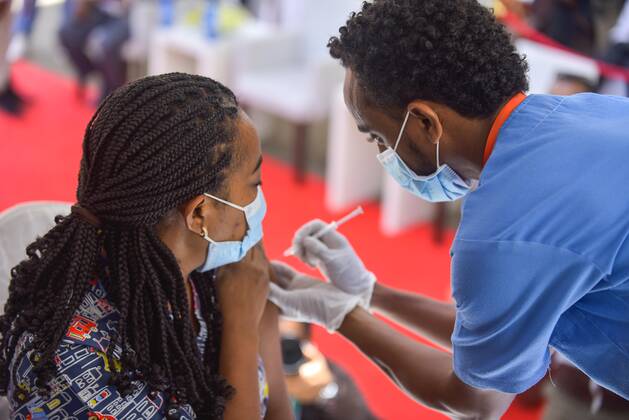 (210313) -- ADDIS ABABA, March 13, 2021 -- A woman receives the COVID-19 vaccine in Addis Ababa, Ethiopia, on March 13, 2021. Ethiopian State Minister of Health Dereje Duguma disclosed on Saturday that the east African country plans to give COVID-19 vaccine jabs to 20 percent of its population by March 2022. Duguma disclosed the plan during a ceremony in Addis Ababa to officially start COVID-19 vaccine jabs in the country. ) ETHIOPIA-ADDIS ABABA-COVID-19 VACCINATION-START MichaelxTewelde 