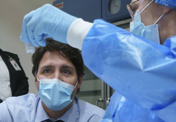 March 15, 2021, Montreal, PQ, Canada: Prime Minister Justin Trudeau looks at a COVID-19 vaccine vial as he tours a vaccination clinic in Montreal, on Monday, March 15, 2021. Montreal Canada  - ZUMAc35_ 20210315_zaf_c35_004 Copyright: xPaulxChiassonx