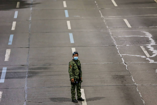 Coronavirus auf den Philippinen, Polizei überwacht Ausgangssperre (210315) -- MANILA, March 15, 2021 -- A policeman is seen at a checkpoint during the implementation of strict quarantine measures in Manila, the Philippines on March 15, 2021. Metro Manila, home to about 13 million people, started imposing strict quarantine measures again on Monday to contain a recent surge of coronavirus infections. The Philippines Department of Health (DOH) reported on Monday that 5,404 new coronavirus disease (COVID-19) infections, the highest daily tally in seven months, bringing the total number of confirmed cases in the country to 626,893. ) PHILIPPINES-MANILA-COVID-19-QUARANTINE MEASURES RouellexUmali