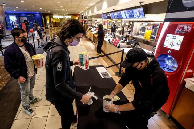 March 15, 2021, Los Angeles, California, USA: Moviegoers wait in line to buy food and drinks at the AMC Theater on the first day of reopened theaters after being closed due to the COVID-19 pandemic in Burbank, California, on March 15, 2021. Los Angeles County restaurants can again welcome customers indoors, and movie theaters and fitness centers are able to reopen, all at limited capacity, with the county advancing today to the less-restrictive red tier of the state s Blueprint for a Safer Economy. Los Angeles USA - ZUMAc68_ 20210315_zaf_c68_011 Copyright: xRingoxChiux