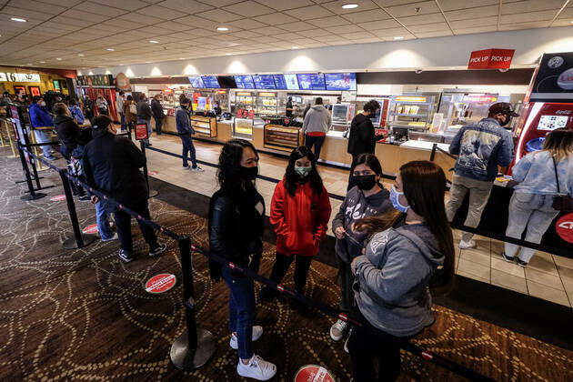 March 15, 2021, Los Angeles, California, USA: Moviegoers wait in line to buy food and drinks at the AMC Theater on the first day of reopened theaters after being closed due to the COVID-19 pandemic in Burbank, California, on March 15, 2021. Los Angeles County restaurants can again welcome customers indoors, and movie theaters and fitness centers are able to reopen, all at limited capacity, with the county advancing today to the less-restrictive red tier of the state s Blueprint for a Safer Economy. Los Angeles USA - ZUMAc68_ 20210315_zaf_c68_014 Copyright: xRingoxChiux