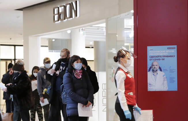 MOSCOW, RUSSIA - MARCH 17, 2021: Citizens queue outside a temporary COVID-19 vaccination site, a mobile team administering the Gam-COVID-Vac (Sputnik V) vaccine free of charge and without prior appointment at the Kuntsevo Plaza shopping centre in western Moscow. Mikhail Metzel TASS  TS0F99CC