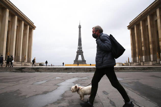 (210317) -- PARIS, March 17, 2021 -- A man walking his dog passes by the Trocadero Place near the Eiffel Tower in Paris, France, March 17, 2021. France has entered a form of third wave (of the coronavirus pandemic) characterized by numerous virus variants, Prime Minister Jean Castex said on Tuesday, stressing that his government still considers vaccination a top priority of its strategy to stem the spread of the virus. On Tuesday, the health authorities reported 29,975 new infections across the country, bringing the cumulative total to 4,108,108. The number of single-day deaths jumped to 408, taking the total to 91,170. ) FRANCE-PARIS-COVID-19-THIRD WAVE GaoxJing