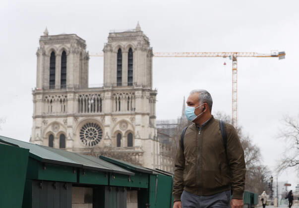 (210317) -- PARIS, March 17, 2021 -- A man wearing a mask walks past the closed Bouquinistes (booksellers of Paris) along the banks of the Seine River in Paris, France, March 17, 2021. France has entered a form of third wave (of the coronavirus pandemic) characterized by numerous virus variants, Prime Minister Jean Castex said on Tuesday, stressing that his government still considers vaccination a top priority of its strategy to stem the spread of the virus. On Tuesday, the health authorities reported 29,975 new infections across the country, bringing the cumulative total to 4,108,108. The number of single-day deaths jumped to 408, taking the total to 91,170. ) FRANCE-PARIS-COVID-19-THIRD WAVE GaoxJing