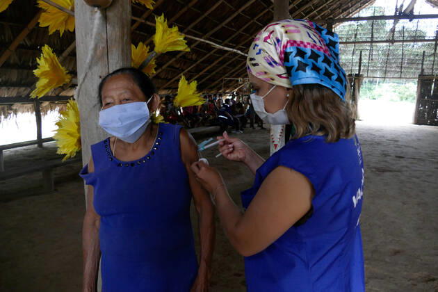 MANAUS, AM - 17.03.2021: VACINAÇÃO DE INDÍGENAS RIBEIRINHOS NO AM - indigenous people of the Tatuyo and Cipia ethnic groups, who live in the riverside community of Araras, are vaccinated against Covid-19, this Wednesday morning (17). In the photo, the nursing technician, Ana Paula, applies the dose of the Oxford AstraZeneca vaccine to the indigenous Terezinha Prado, 63, from the Cipia tribe. x2043632x  SandroxPereira