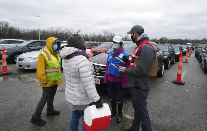Vaccinators prepare to give Covid-19 vaccination shots at the Family Arena during a mass vaccination drive-in event in St. Charles, Missouri on Thursday, March 18, 2021. The event attracted 4,000 people, some waiting over four hours in their cars for their first shot to protect them from the coronavirus.  SLP2021031811 BILLxGREENBLATT