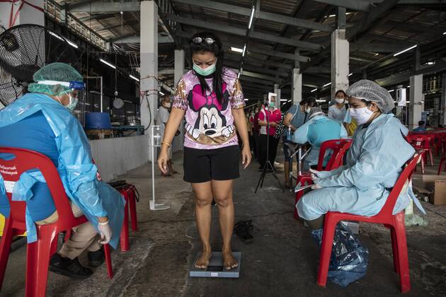 March 19, 2021, Thailand: A woman is weighed before lining up to receive a dose of CoronaVac, a Covid-19 coronavirus vaccine developed by China s Sinovac Biotech ltd. Health workers have been vaccinating 600 residents per day, after a cluster of Covid-19 coronavirus cases were discovered at the Bang Khae market. Thailand - ZUMAm249 20210319_zip_m249_018 Copyright: xAndrexMalerbax