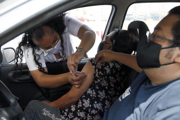 March 19, 2021, Nezahualcoyotl City, State Of Mexico, Mexico: A health worker, injects a Sinovac Covid19 vaccine to an elderly inside a car at the Sports City Garden, in the municipality of Nezahualcoyotl in the State of Mexico, during a immunization program to drivers against Covid19. On March 19, 2021 in Nezahualcoyotl City, Mexico. Nezahualcoyotl City Mexico - ZUMAe321 20210319_zia_e321_008 Copyright: xLuisxBarronx