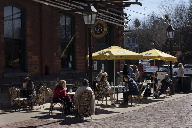 March 20, 2021, Toronto, on, Canada: Customers sit on a patio at a coffee shop in the Distillery district in Toronto, Saturday, March 20, 2021. Starting today, restaurants in Toronto and Peel Region can offer customers outdoor dining. Toronto Canada  - ZUMAc35_ 20210320_zaf_c35_007 Copyright: xChrisxYoungx