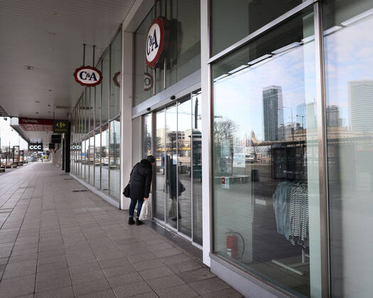 (210320) -- WARSAW, March 20, 2021 -- A woman looks through the window of a closed shop in central Warsaw, Poland, on March 20, 2021. The government of Poland announced a new nationwide partial lockdown on Friday after the cumulative number of COVID-19 cases since the start of the pandemic exceeded two million in the country. Starting on Saturday, only a select number of shops -- among them supermarkets and pharmacies -- located in shopping malls with over 2,000 square meters of retail space are allowed to operate. Cinemas, theaters and museums will have to remain closed, and schools will return to online learning. (Photo by Xinhua) POLAND-WARSAW-COVID-19-PARTIAL LOCKDOWN JaapxArriens 