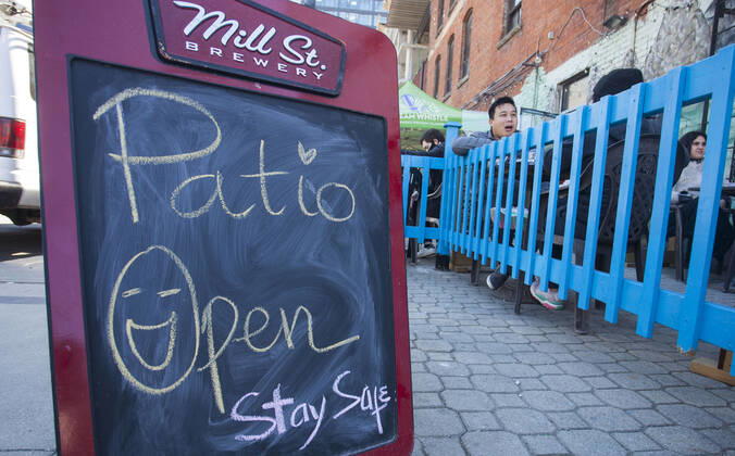 (210320) -- TORONTO, March 20, 2021 -- A notice of Patio Open is seen outside a restaurant in Toronto, Canada, on March 20, 2021. With distancing rules and a number of other public health and workplace safety measures, outdoor dining was allowed to resume Saturday in Toronto under modifications to the Ontario s color-coded pandemic response framework. (Photo by Xinhua) CANADA-TORONTO-COVID-19-OUTDOOR DINING-RESUME ZouxZheng 
