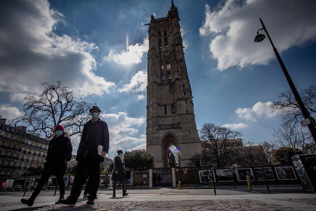 (210320) -- PARIS, March 20, 2021 -- People with face masks walk on a street in Paris, France, on March 20, 2021. French Prime Minister Jean Castex on Thursday announced new massive measures to curb COVID-19 in the country s 16 worst-hit regions, including Paris. Starting Friday midnight, about 18 million French people in regions such as Paris, Hauts-de-France in the north as well as the Alpes-Maritimes on the Mediterranean should stay at home, Castex announced at a press briefing on the epidemic situation. (Photo by Xinhua) FRANCE-PARIS-COVID-19-PARTIAL LOCKDOWN AurelienxMorissard 