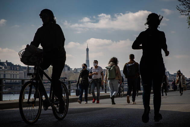 (210320) -- PARIS, March 20, 2021 -- People walk along the bank of Seine in Paris, France, on March 20, 2021. French Prime Minister Jean Castex on Thursday announced new massive measures to curb COVID-19 in the country s 16 worst-hit regions, including Paris. Starting Friday midnight, about 18 million French people in regions such as Paris, Hauts-de-France in the north as well as the Alpes-Maritimes on the Mediterranean should stay at home, Castex announced at a press briefing on the epidemic situation. (Photo by Xinhua) FRANCE-PARIS-COVID-19-PARTIAL LOCKDOWN AurelienxMorissard 