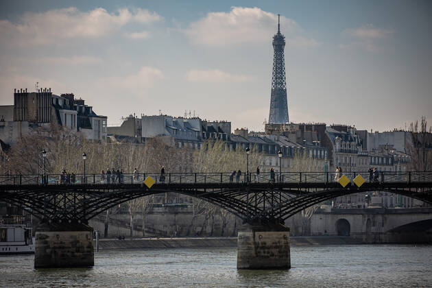 (210320) -- PARIS, March 20, 2021 -- People walk on the Pont des Arts bridge in Paris, France, on March 20, 2021. French Prime Minister Jean Castex on Thursday announced new massive measures to curb COVID-19 in the country s 16 worst-hit regions, including Paris. Starting Friday midnight, about 18 million French people in regions such as Paris, Hauts-de-France in the north as well as the Alpes-Maritimes on the Mediterranean should stay at home, Castex announced at a press briefing on the epidemic situation. (Photo by Xinhua) FRANCE-PARIS-COVID-19-PARTIAL LOCKDOWN AurelienxMorissard 