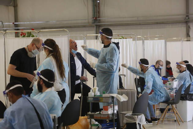 (210321) -- TEL AVIV, March 21, 2021 -- Travelers receive COVID-19 tests upon their arrival at Ben Gurion International Airport near Tel Aviv, Israel, on March 21, 2021. Israel has lifted a restriction on the number of incoming and outgoing passengers at the airport after the Supreme Court ruled that the two-month-long measure has been unconstitutional. (Photo by Xinhua) ISRAEL-BEN GURION INTERNATIONAL AIRPORT-COVID-19-RESTRICTION-LIFTING GilxCohenxMagen 