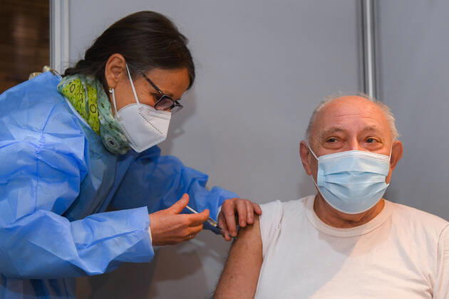A man receives a vaccin shot after the opening of a new vaccination center in Anderlecht, in the Lotto Arena (RSCA stadium), Monday 22 March 2021.  LAURIExDIEFFEMBACQ 2677095