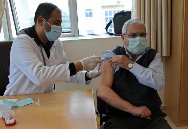 (210322) -- GAZA, March 22, 2021 -- A Palestinian man receives a dose of COVID-19 vaccine in Gaza City, March 22, 2021. (Photo by Xinhua) MIDEAST-GAZA CITY-COVID-19-VACCINATION RizekxAbdeljawad 