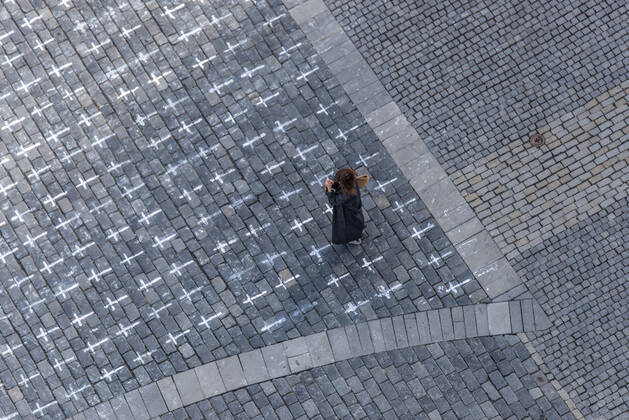 The Million Moments for Democracy civic group honored the memory of those who died with coronavirus by drawing thousands of little crosses at Old Town Square in Prague, Czech Republic, March 22, 2021. The cross should also symbolize the ineffectiveness of the government s COVID combat. (CTKxPhoto JanaxPlavec) CTKPhotoF202103221073301 