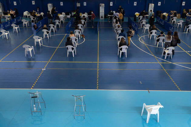 March 22, 2021, Santiago, Metropolitana, Chile: People wait to receive the dose of the Sinovac or Pfizer vaccine, in a municipal stadium transformed into a vaccination center against covid in Santiago, Chile. Santiago Chile - ZUMAb332 20210322_zip_b332_003 Copyright: xMatiasxBasualdox